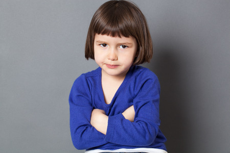 kid attitude concept - cute 4-year old child with bob cut making a statement in crossing arms for disagreement,studio shotの写真素材