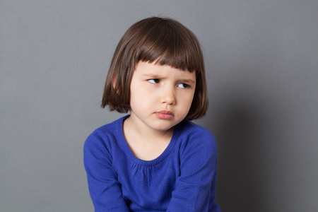 kid attitude concept - grumpy 4-year old child with bob cut sulking with dirty look for complain or disagreement,studio shotの写真素材