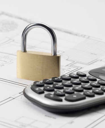 lock and calculator on construction blueprintの写真素材