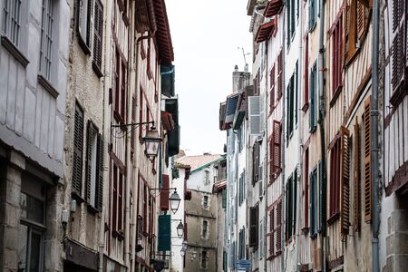 old regional beautiful street and facades with colorful wooden blinds and timbers for tourism in the South West of France in Europeの写真素材