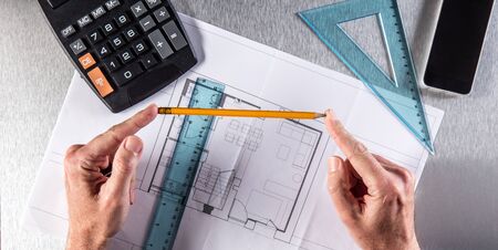 businessman in reflection with a pencil in hands in working on a new property or architect hands in...