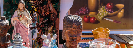 retro and ethnic sale with various religion symbols, painting, dishes, decorative African statues...