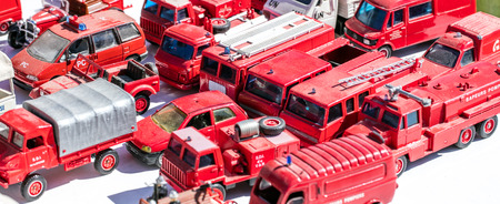 collector display for metallic firefighter truck and red car specialists at garage sale, flea market...