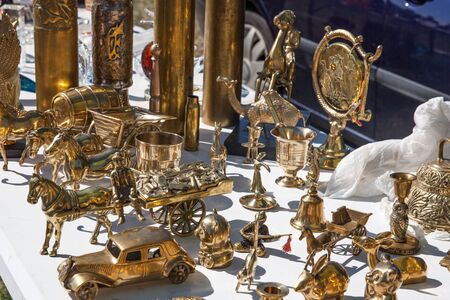 display of second hand brass objects in shape of animals such as horse, bear or camel for decoration or retro collection sold at flea market or garage saleの写真素材
