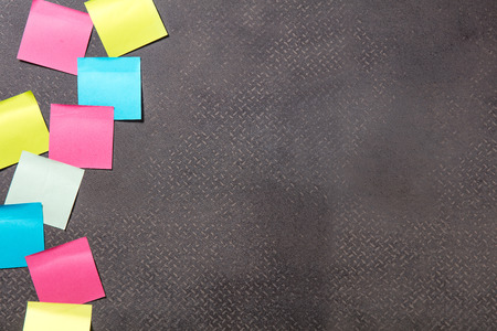 colorful blank sticky notes on copy space concrete background table for student memo, education message or business communication, top viewの写真素材