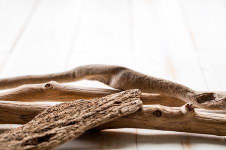 concept of serenity, wellness, relaxation and inner beauty with textured drift wood over empty white flooring for lifestyle copy spaceの写真素材