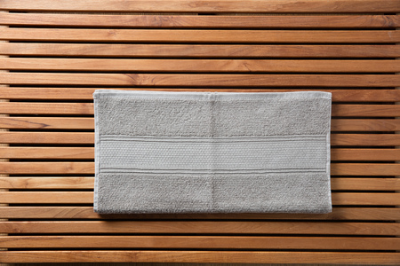 Hammam, sauna, shower, bath, hygiene, spa, body care concepts with grey cotton towel set over beautiful wooden board, beauty spa, copy space wallpaperの写真素材