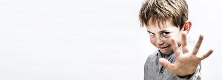 long banner of cheeky little boy with hand forward stopping or reaching out for boundary concept at school or parenthoodの写真素材