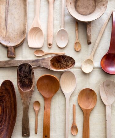 different empty kitchen spoons made of different woods. Old, ancient, carved, big or small, rustic or design for graphical cuisine background, top viewの写真素材