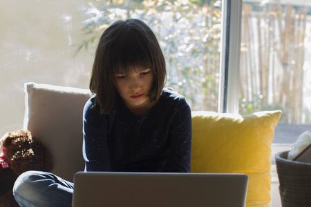 sad quarantine child learning from home computer and online classes while sad covid-19 pandemic...