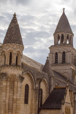 Roman church of Poitiers, France: Notre Dame-La-Grande towers over beautiful grey skyの写真素材