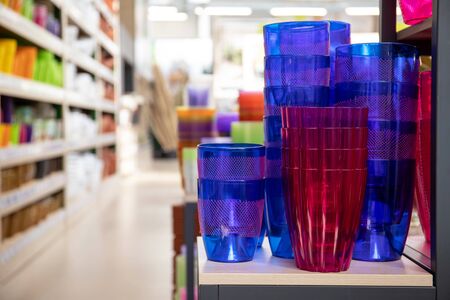 Flower shop interior. Bright multi-colored plastic pots on a shelf.の写真素材