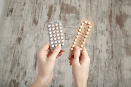 Girl holds birth control pills in her hands. Contraceptionの写真素材