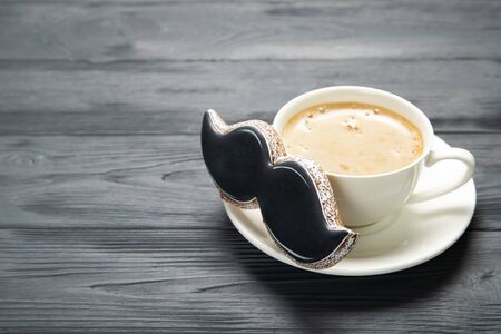 Happy father's day concept. Cup of cafe and cookies on a wooden background. Place for textの写真素材