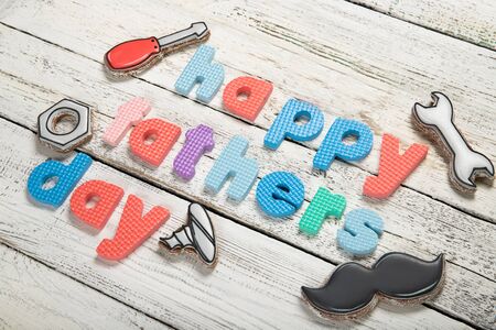 Happy father's day concept. Cookies on a black background. Text happy father's day
