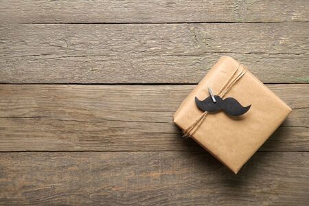 Happy father's day concept. Gift on a wooden background. Place for textの写真素材