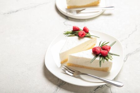 Plate with delicious raspberry cheesecake. On a wooden backgroundの写真素材