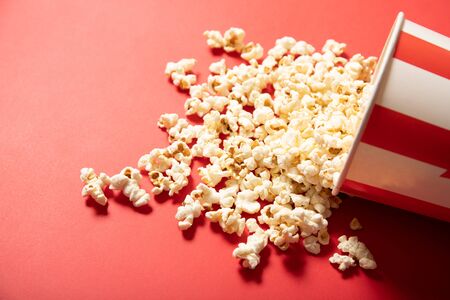 Paper cup with popcorn on a red backgroundの写真素材