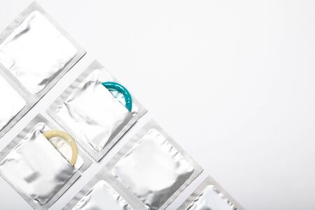 Condoms on a white background. Colored condoms. Contraceptionの写真素材