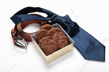 Tie, belt and box with cookies. Gift to dad. Happy father's dayの写真素材