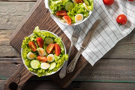 Tasty salad of fresh vegetables with quail eggs. Diet conceptの写真素材