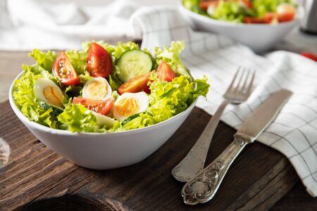 Tasty salad of fresh vegetables with quail eggs. Diet conceptの写真素材