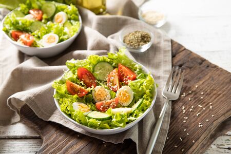 Tasty salad of fresh vegetables with quail eggs. Diet conceptの写真素材