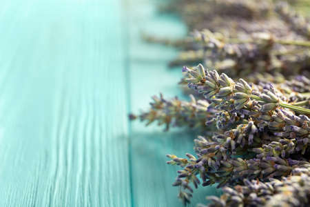 Lavender flowers on a blue wooden background. Place for text