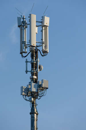 close-up of antenna mast for mobile radio communications in front of blue sky
