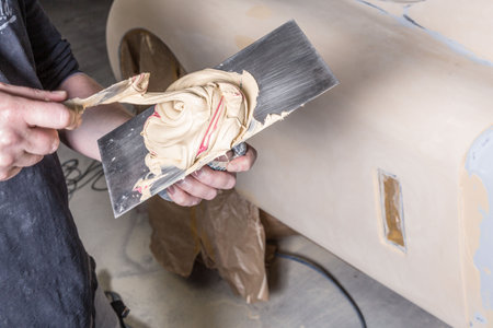 Close-up of mixing two-component adhesive for using on an classic carの写真素材