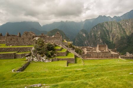The ancient city of Machu Picchu, Peru. Overlooking ruins on the Inca citadel in the Andes Mountains and the river valley belowの写真素材