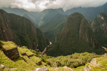 The ancient city of Machu Picchu, Peru. Overlooking ruins on the Inca citadel in the Andes Mountains and the river valley belowの写真素材