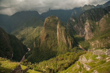 The ancient city of Machu Picchu, Peru. Overlooking ruins on the Inca citadel in the Andes Mountains and the river valley belowの写真素材
