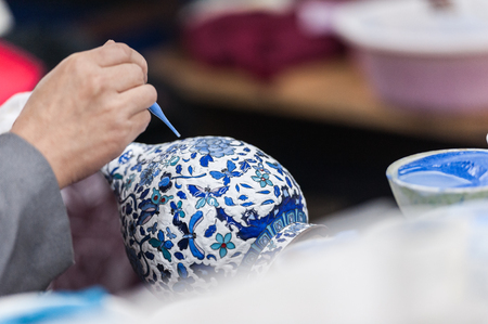 Workshop making enamel items such as bowls, vases and other home decor items in Beijing, China. Shots of porcelain enamel paint made from powdwred glass applied to metal surfaces.の写真素材