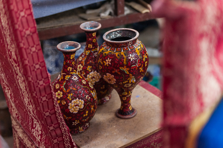 Workshop making enamel items such as bowls, vases and other home decor items in Beijing, China. Shots of porcelain enamel paint made from powdwred glass applied to metal surfaces.の写真素材