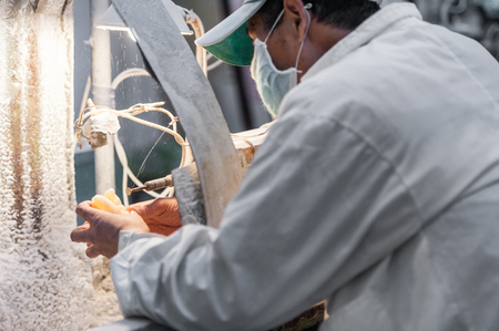 Chinese man working in the workshop making jade or stone items in Beijing, China.の写真素材