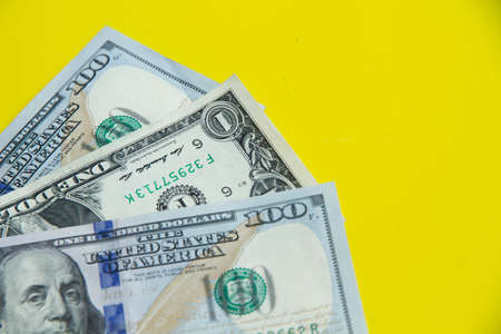 Dollars on yellow background American currencyの写真素材