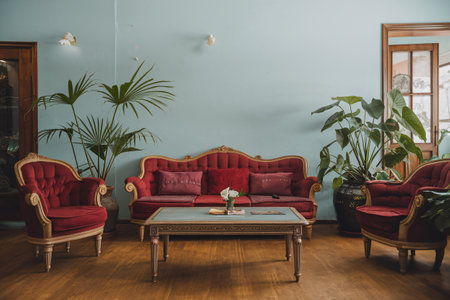 Interior of living room with red sofa, coffee table and plantsの素材