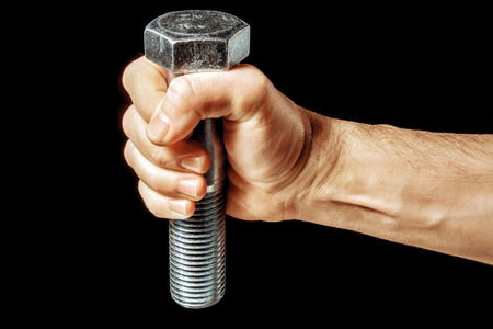An isolated steel bolt in male handの写真素材