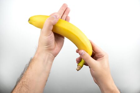 image of hands holding banana handle sexual gestures on isolated white background
