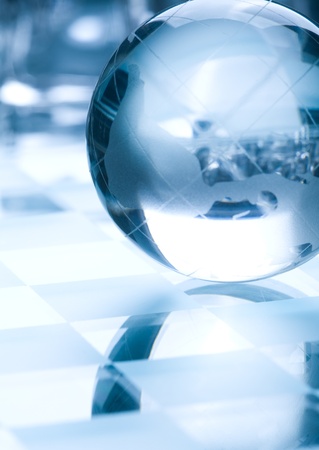 Globe made of glass in blue ambient light  の写真素材