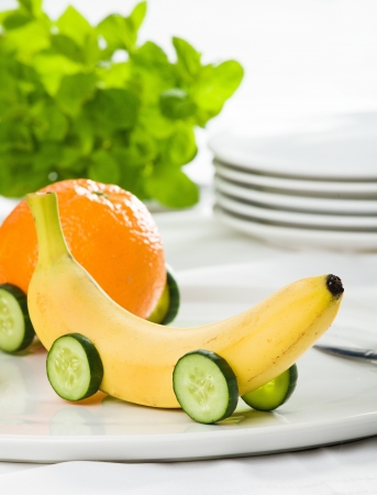 Banana with cucumber wheelsの写真素材