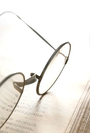 Old glasses on ancient bookの写真素材