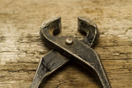 old vintage metal cutters on wooden backgroundの写真素材