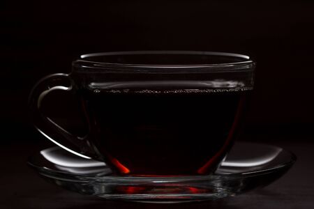 the black Cup of hot tea on wooden tableの写真素材