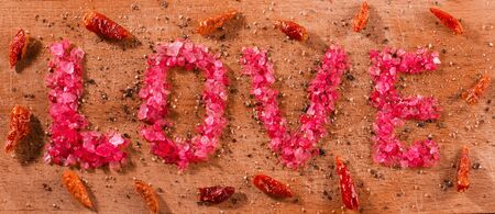 the inscription "love" sea salt on wooden backgroundの写真素材