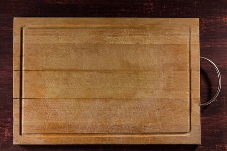 Empty cutting board on planks food background concept