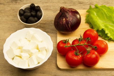 Home cooking summer Greek salad on wooden backgroundの写真素材