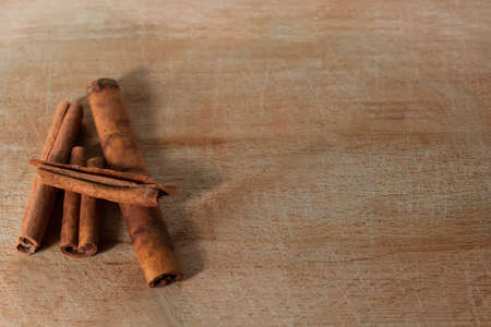 whole cinnamon sticks on wooden backgroundの写真素材