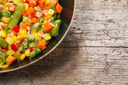 vegetable mix in the pan on wooden backgroundの写真素材